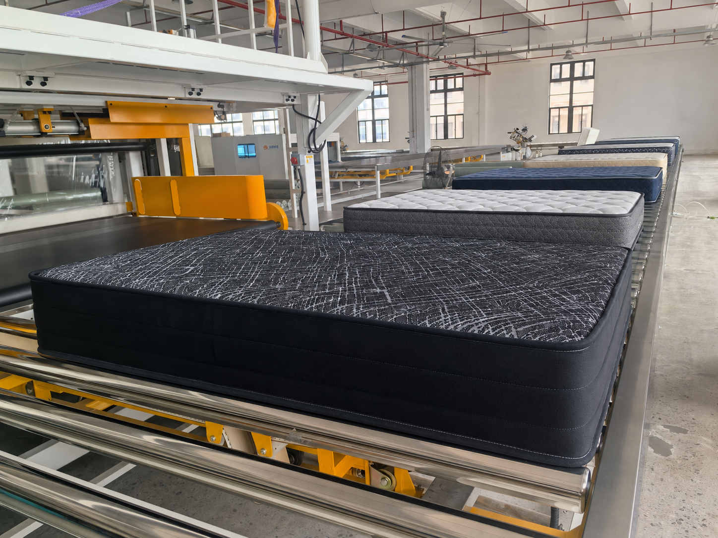 Mattress production line in a mattress manufacturing facility